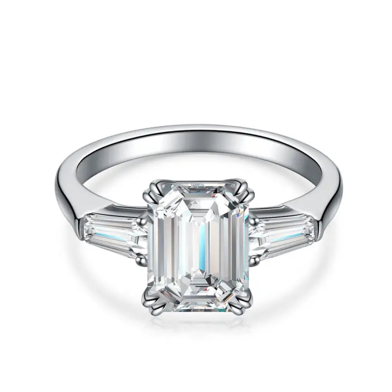 Diamond engagement ring with an emerald-cut center stone and tapered baguette side stones.