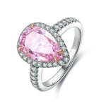 Load image into Gallery viewer, Silver ring featuring a pear-shaped pink gemstone surrounded by smaller diamonds.
