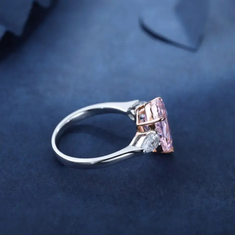 Silver ring with a rectangular pink gemstone.