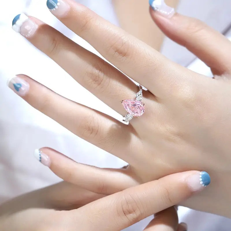 Delicate ring featuring a pink heart-shaped gemstone.