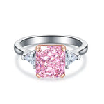 Load image into Gallery viewer, Engagement ring featuring a pink rectangular diamond center stone flanked by two smaller white diamonds.
