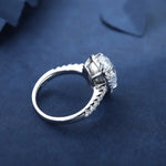 Load image into Gallery viewer, Diamond engagement ring with a prominent center stone and smaller diamonds along the band.
