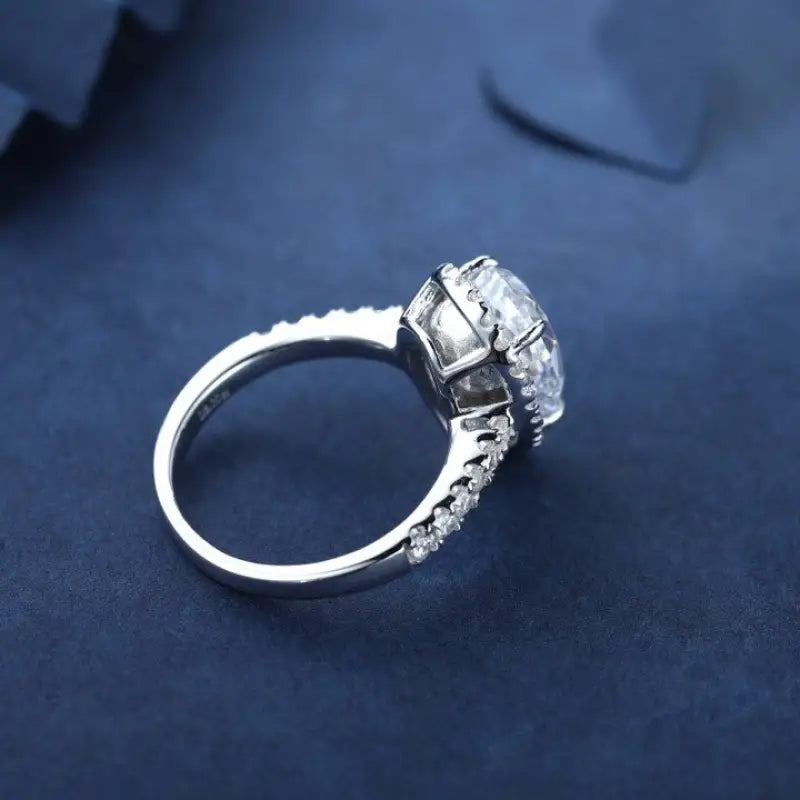 Diamond engagement ring with a prominent center stone and smaller diamonds along the band.