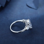 Load image into Gallery viewer, Diamond engagement ring with a square-cut center stone and smaller accent diamonds.
