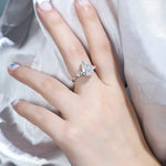 Load image into Gallery viewer, Diamond engagement ring with a pear-shaped center stone and side accents.
