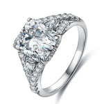 Load image into Gallery viewer, Ornate diamond engagement ring with a prominent cushion-cut center stone and intricate side detailing.
