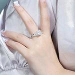 Load image into Gallery viewer, Diamond engagement ring on a woman’s hand.
