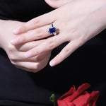 Load image into Gallery viewer, Sapphire and diamond ring on a person’s hand.
