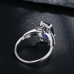 Load image into Gallery viewer, Silver engagement ring with a square-cut blue gemstone in a prong setting.
