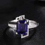 Load image into Gallery viewer, Elegant silver ring featuring a deep blue rectangular gemstone surrounded by small diamonds.
