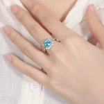 Load image into Gallery viewer, Aquamarine gemstone ring with diamond accents set in white metal.
