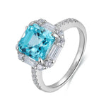 Load image into Gallery viewer, Elegant silver ring featuring a square-cut blue gemstone surrounded by smaller diamonds.
