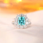 Load image into Gallery viewer, Ornate ring featuring a cushion-cut aquamarine gemstone surrounded by diamonds.
