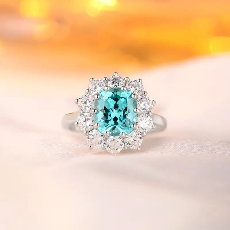 Ornate ring featuring a cushion-cut aquamarine gemstone surrounded by diamonds.