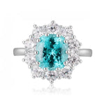 Load image into Gallery viewer, Elegant ring featuring a vibrant blue-green gemstone surrounded by sparkling diamonds.
