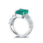 Load image into Gallery viewer, Silver ring featuring a square-cut emerald gemstone and baguette diamonds on the band.
