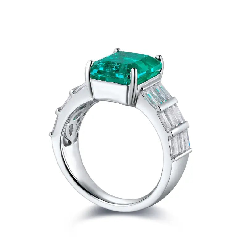 Silver ring featuring a square-cut emerald gemstone and baguette diamonds on the band.