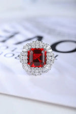 Load image into Gallery viewer, Ornate ring featuring a square-cut red gemstone surrounded by smaller clear stones.
