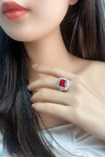 Load image into Gallery viewer, Ornate ring featuring a square-cut red gemstone surrounded by smaller clear stones.
