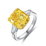 Load image into Gallery viewer, Yellow diamond engagement ring with baguette side stones set in a white metal band.
