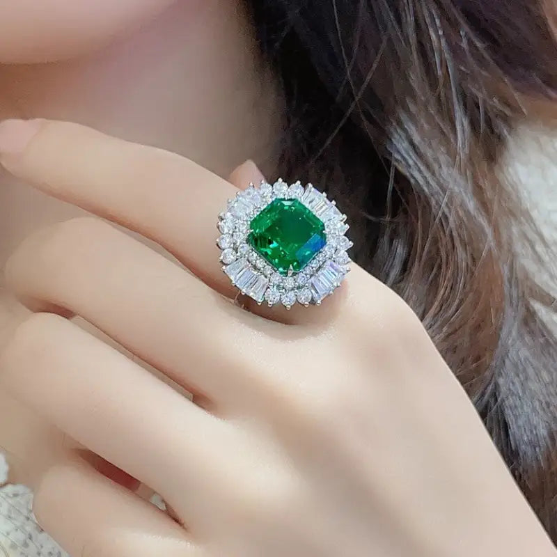 Ornate ring featuring a vibrant emerald-green gemstone surrounded by diamond accents.