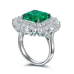 Load image into Gallery viewer, Ornate silver ring featuring a prominent emerald-green gemstone surrounded by smaller diamonds.
