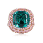 Load image into Gallery viewer, Ornate ring featuring a cushion-cut emerald gemstone surrounded by pink diamonds.
