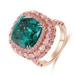 Load image into Gallery viewer, Ornate gold ring featuring a prominent emerald-green gemstone surrounded by pink diamonds.
