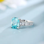 Load image into Gallery viewer, Elegant ring featuring a cushion-cut aquamarine gemstone with diamond accents on the band.
