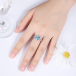 Load image into Gallery viewer, Silver ring with a prominent light blue gemstone.
