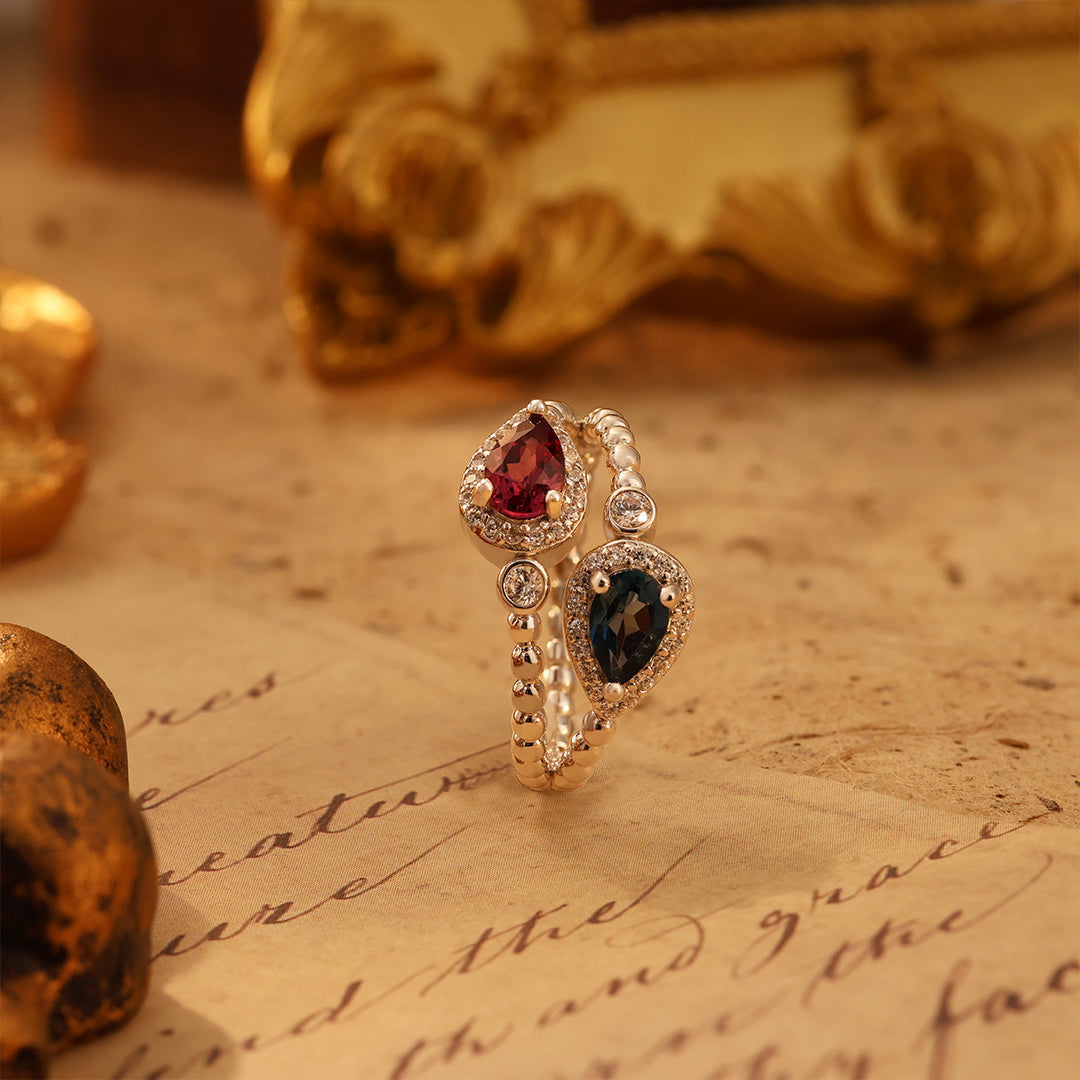 Pear Cut Blue Topaz & Garnet Toi Et Moi Ring