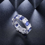 Load image into Gallery viewer, Elegant ring featuring alternating blue sapphires and clear diamonds set in a white metal band.
