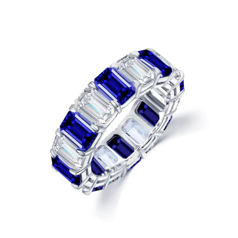 Elegant ring featuring alternating emerald-cut sapphires and diamonds in a band setting.