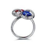 Load image into Gallery viewer, Elegant silver ring featuring a blue sapphire and red ruby in an infinity-inspired design.
