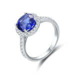 Load image into Gallery viewer, Elegant silver ring featuring a deep blue gemstone surrounded by small diamonds.
