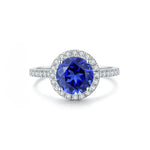 Load image into Gallery viewer, Sapphire and diamond halo engagement ring with a white gold band.
