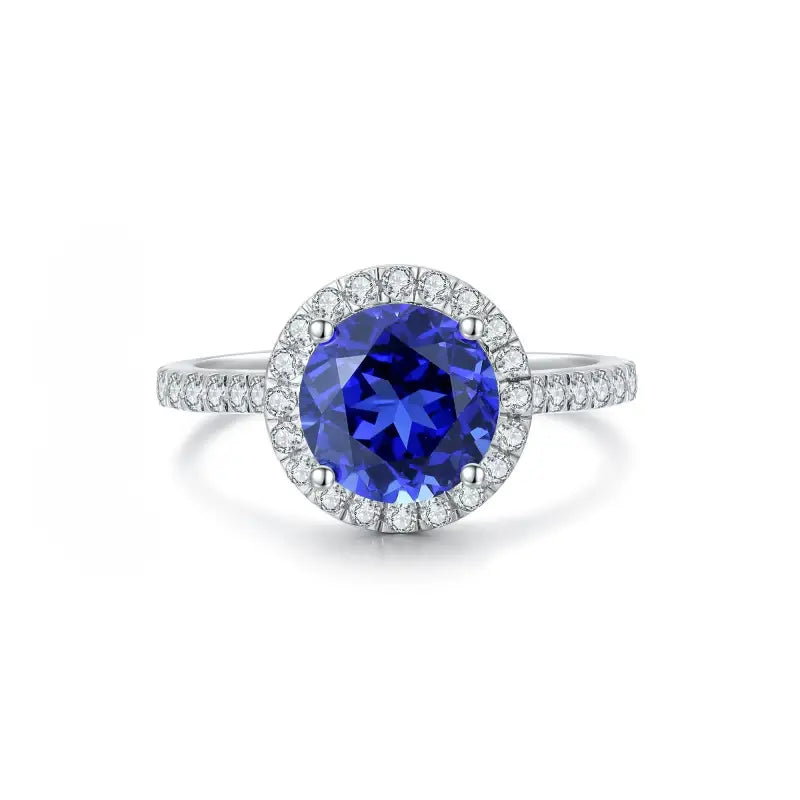 Sapphire and diamond halo engagement ring with a white gold band.