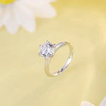 Load image into Gallery viewer, Diamond solitaire engagement ring with a silver band.
