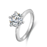 Load image into Gallery viewer, Diamond solitaire engagement ring with a round brilliant cut stone set in a six-prong white metal band.
