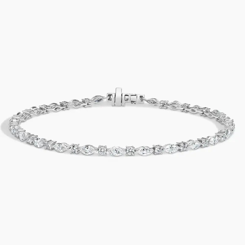 Delicate diamond tennis bracelet with oval-cut stones set in a silver or white gold chain.