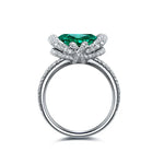 Load image into Gallery viewer, Ornate silver ring featuring a prominent emerald-green gemstone surrounded by diamond accents.
