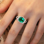 Load image into Gallery viewer, Emerald-colored gemstone ring with a diamond-encrusted setting.
