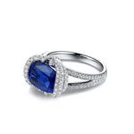 Load image into Gallery viewer, Sapphire and diamond engagement ring with a cushion-cut center stone.
