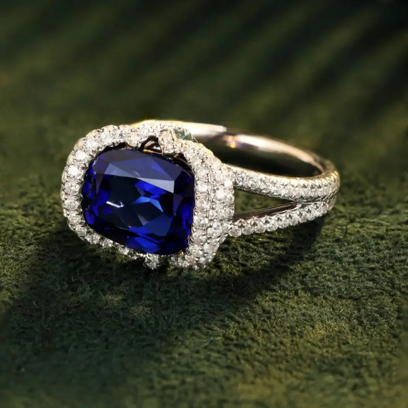 Sapphire and diamond ring with a cushion-cut center stone.