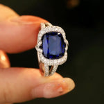 Load image into Gallery viewer, Sapphire and diamond ring with a rectangular blue gemstone centerpiece.
