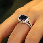 Load image into Gallery viewer, Sapphire and diamond engagement ring with a halo design.
