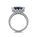 Load image into Gallery viewer, Ornate silver ring featuring a prominent blue gemstone surrounded by diamond accents.
