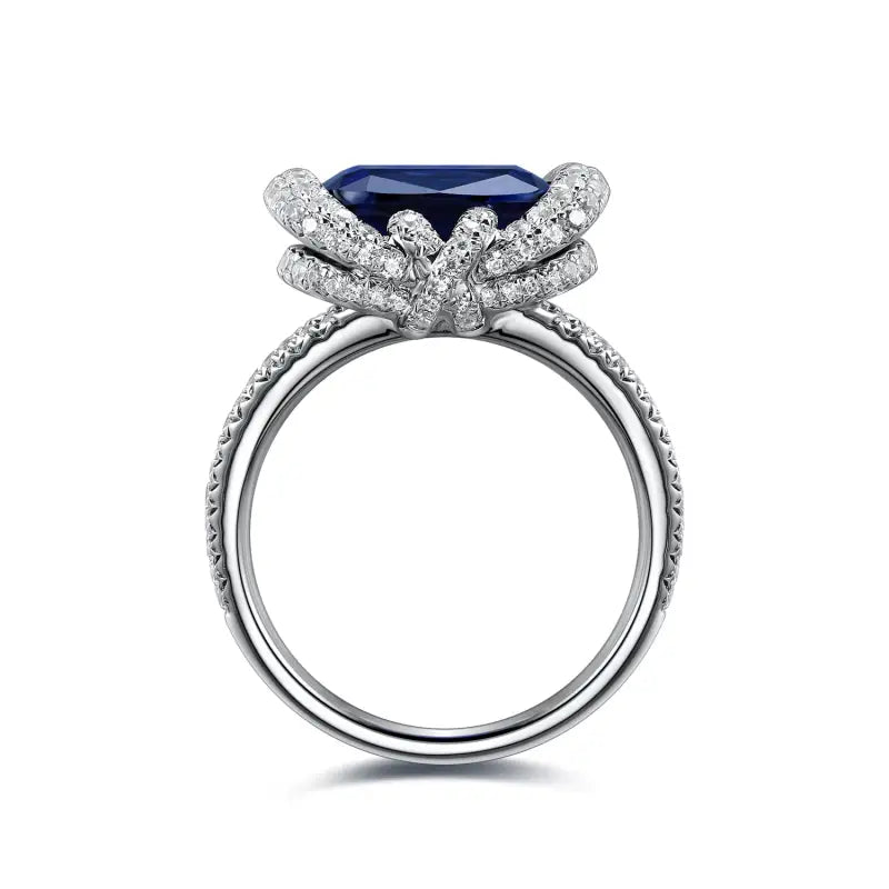 Ornate silver ring featuring a prominent blue gemstone surrounded by diamond accents.