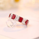 Load image into Gallery viewer, Elegant ring featuring alternating red and clear gemstones in a band setting.
