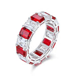 Load image into Gallery viewer, Elegant eternity ring featuring alternating red and clear gemstones in a silver-toned setting.
